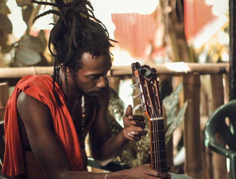 a man with dreadlocks sitting on a chair