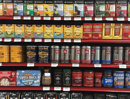 Round Hill Market shelf with coffee, tea, and juice brands like Stash, Twinings, Illy, and Ceres.
