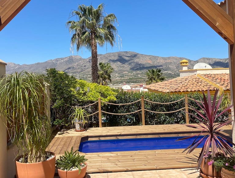 a pool with a wooden deck and a wooden deck