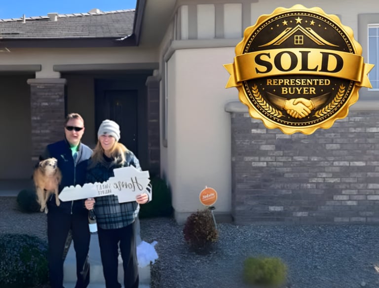 a man and woman standing in front of a sold sign