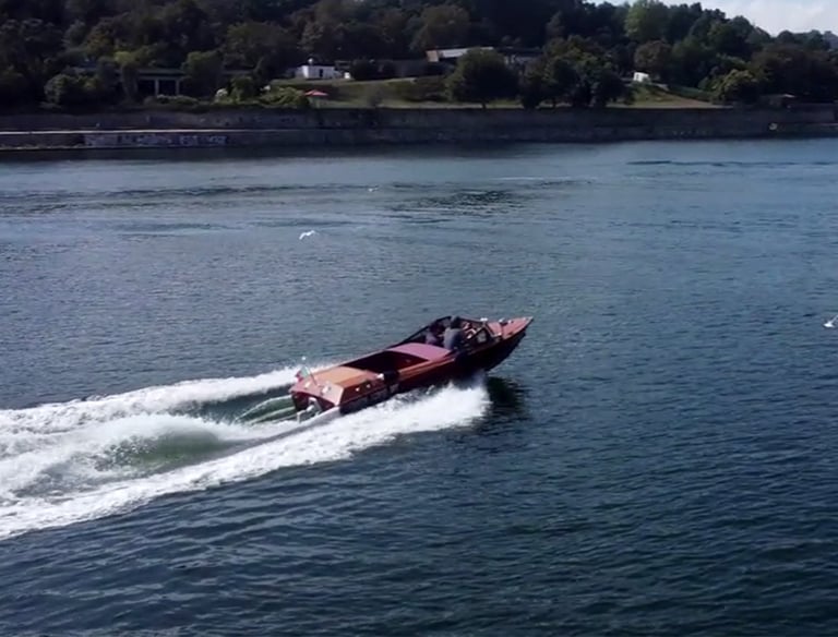 Guests enjoying a James Bond–style ride on Eskrok, a classic speedboat on the Douro River