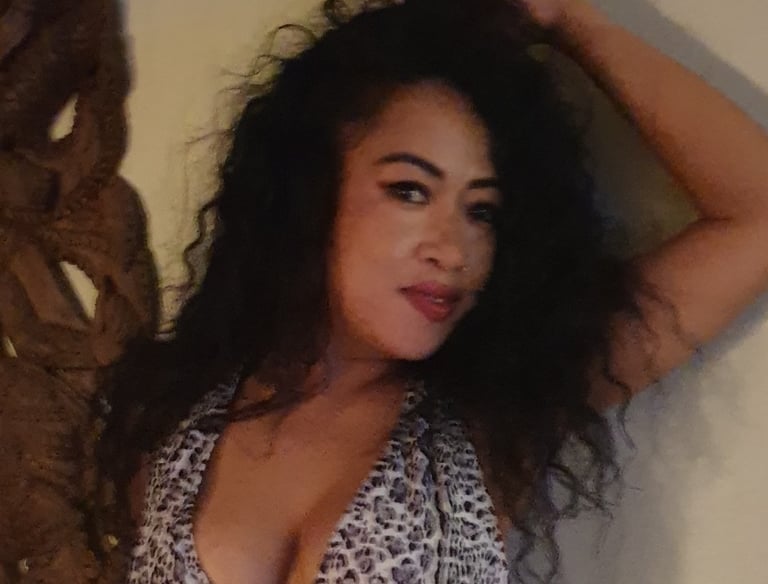 lady posed with arm raised and hand touching head