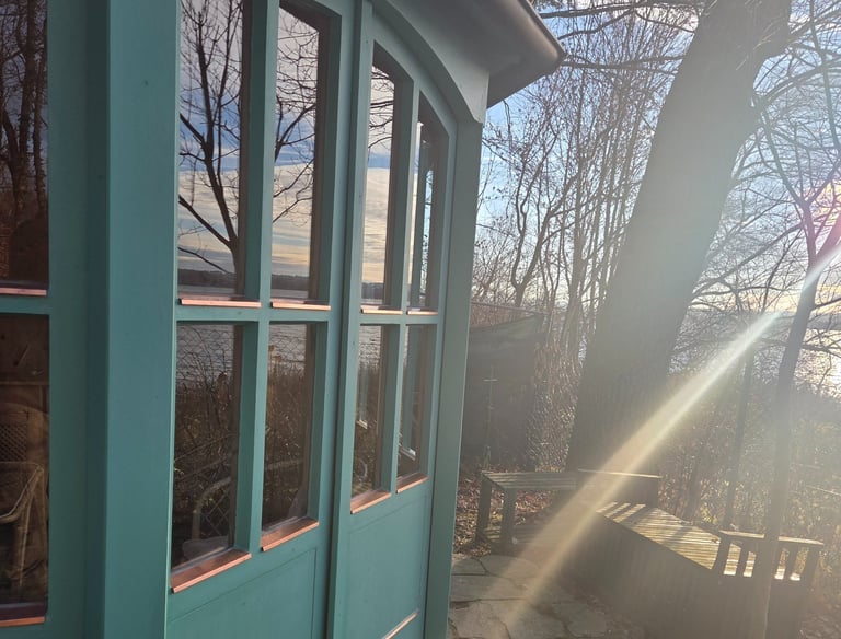 Grüner Holzpavillon mit verglasten Flügeltüren und Kupferdetails am Ufer des Ammersees von Holztechnik Volk