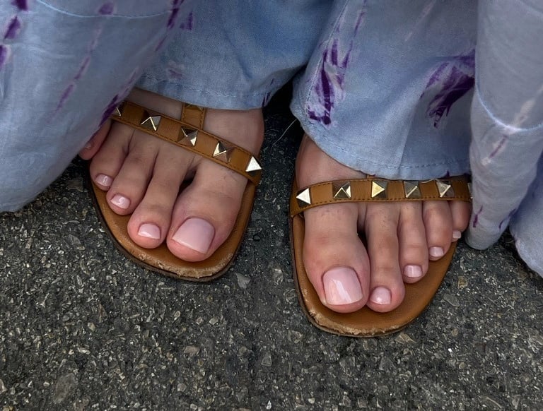 a person wearing sandals and a pair of sandals