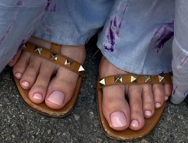 a person wearing sandals and a pair of sandals