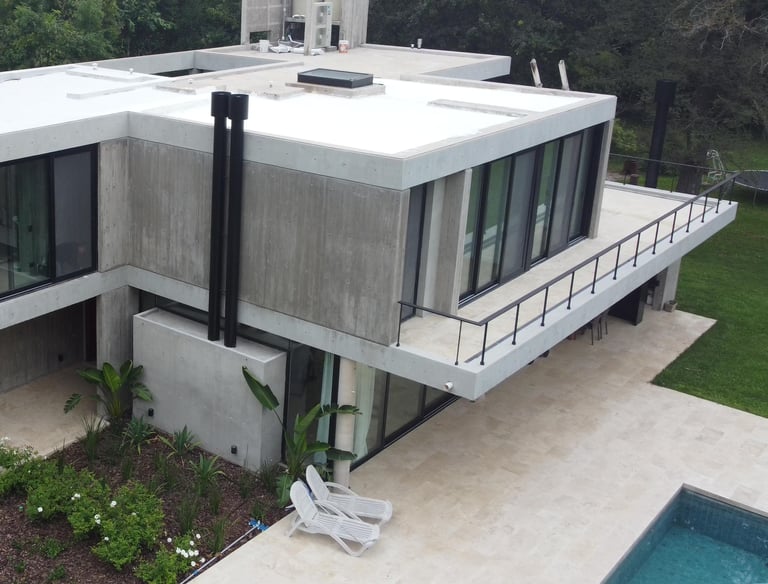 a house with a large roof and a pool