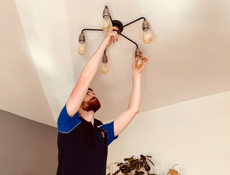 GigaVolt electrician installing a decorative light fitting