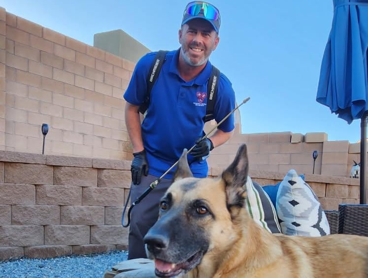 l and m pest control service technician with client dog