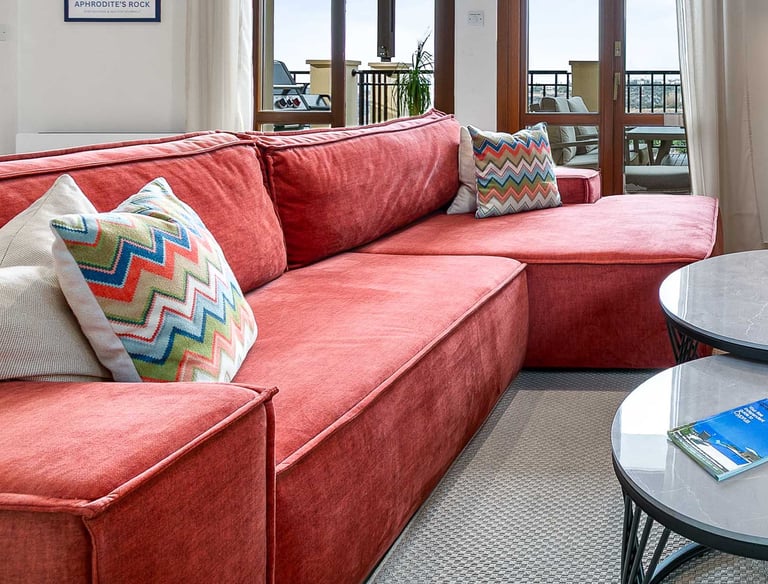 Living room seating area with large TV and sea view at Theseus Retreat holiday rental
