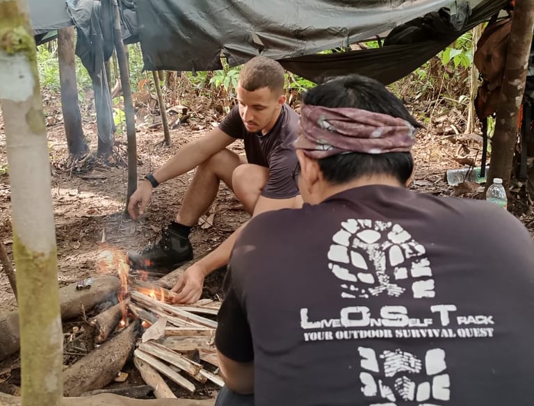 a group of people sitting around a campfire