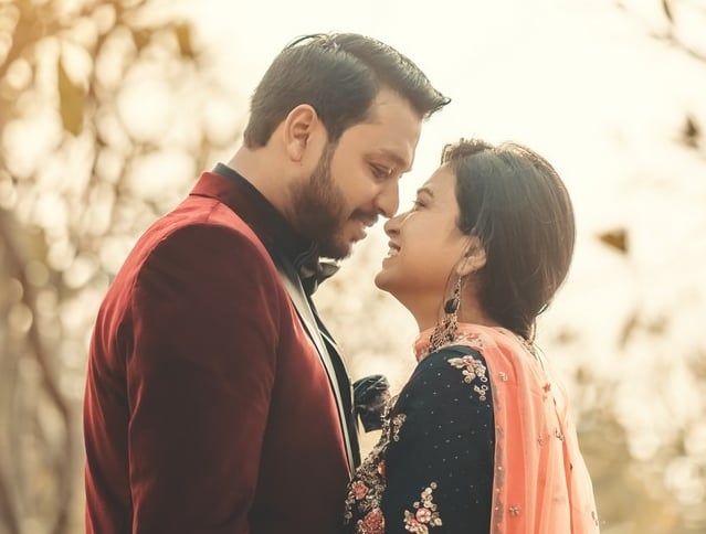 a couple standing next to each other in a tree