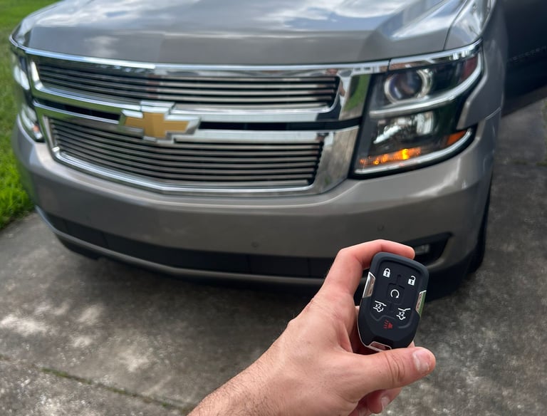 Automotive locksmith unlocking car door and making replacement keys in North Florida