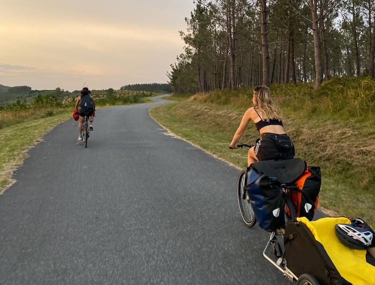 Two persons riding bikes on a beatiful road