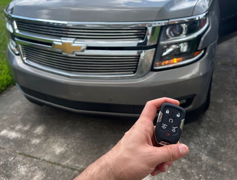 Automotive locksmith unlocking car door and making replacement keys in North Florida