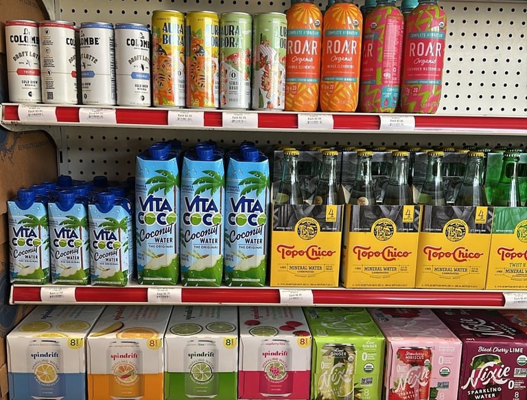 Beverage shelf at Round Hill Market with drinks like La Colombe Latte, Aura Bora, ROAR Organic, Vita Coco, and Spindrift.