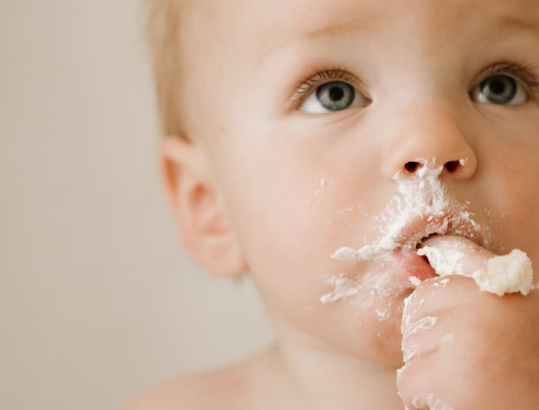 baby eating cake at his cake smash photography session in Adelaide Hills