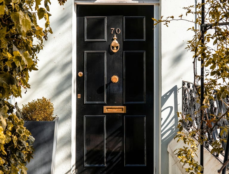a black door with a black door and gold numbering