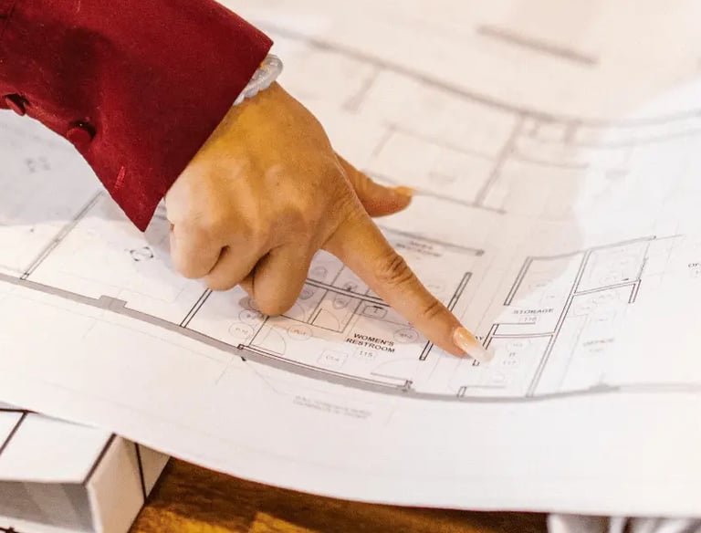Home buyers reviewing a detailed floor plan before purchase