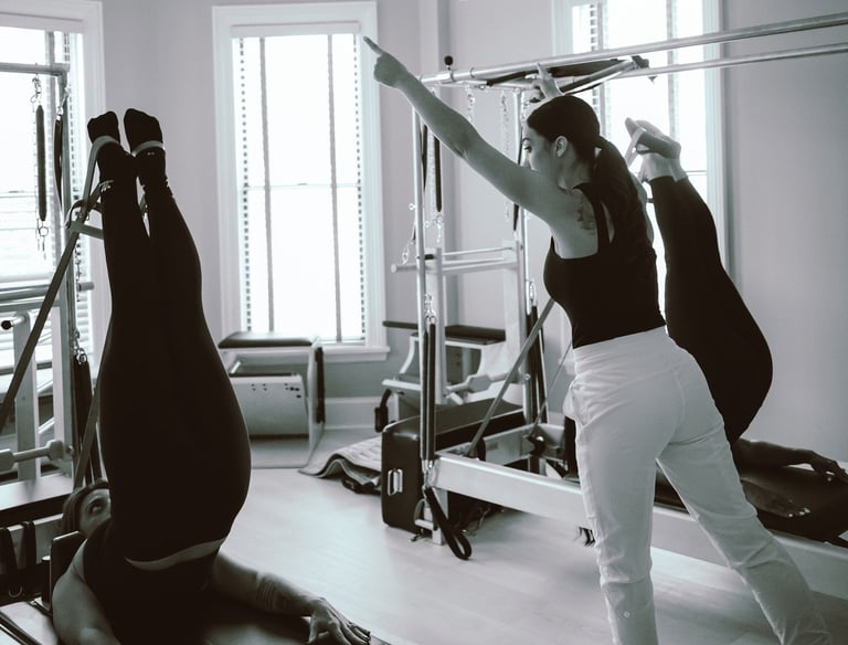 photo of 27 Pilates owner and instructor Tina Blondin giving a semi private reformer class
