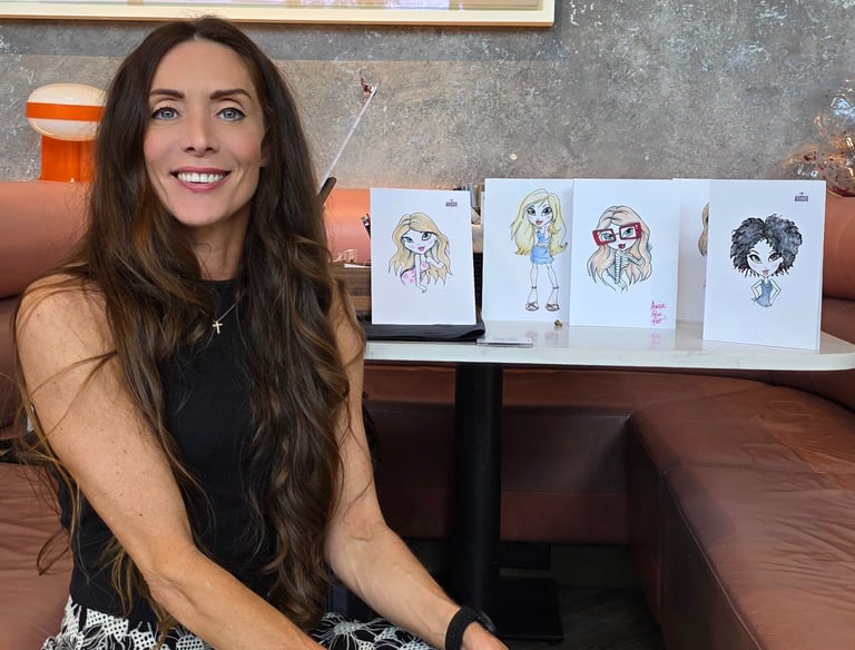 a woman sitting on a couch in a room in a resturaunt of some illustrations she has drawn