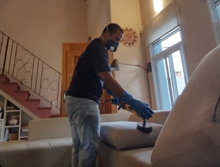 Limpeza de sofá bege em Campinas -procedimento técnico com escovação e proteção individual.