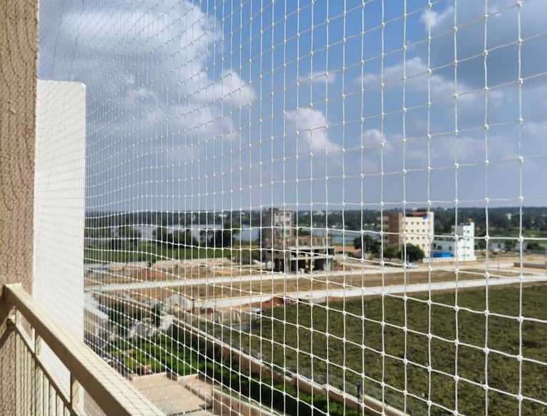 Happy family enjoying their balcony safely protected by a net.