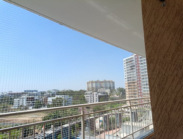 Close-up of tough, weather-resistant pigeon netting neatly installed on a window.