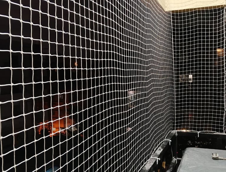 Wide shot showing a clean and safe balcony fully covered with quality safety nets.