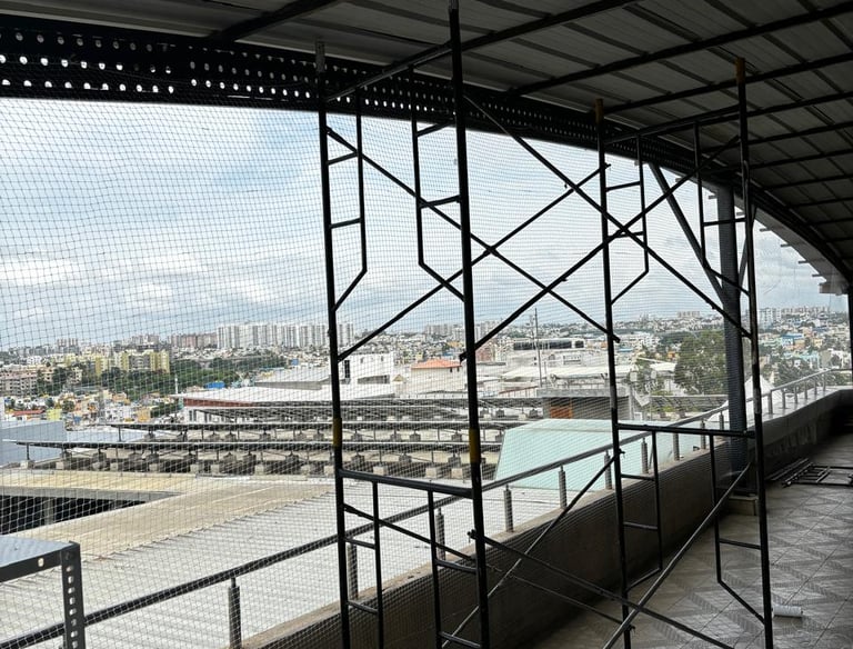 Wide shot of a large warehouse fully covered with pigeon safety nets to prevent bird entry.