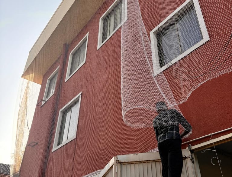 Close-up of sturdy pigeon netting installed on a balcony in Jalahalli.
