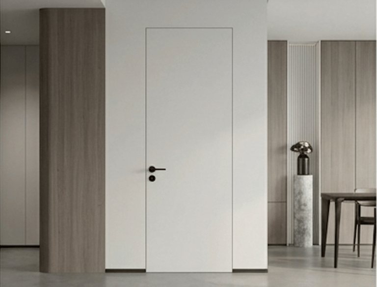 Modern white frameless hidden door with black handle in a minimalist interior design.