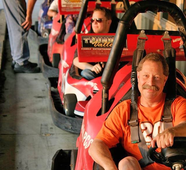 man posing in outdoor go kart line