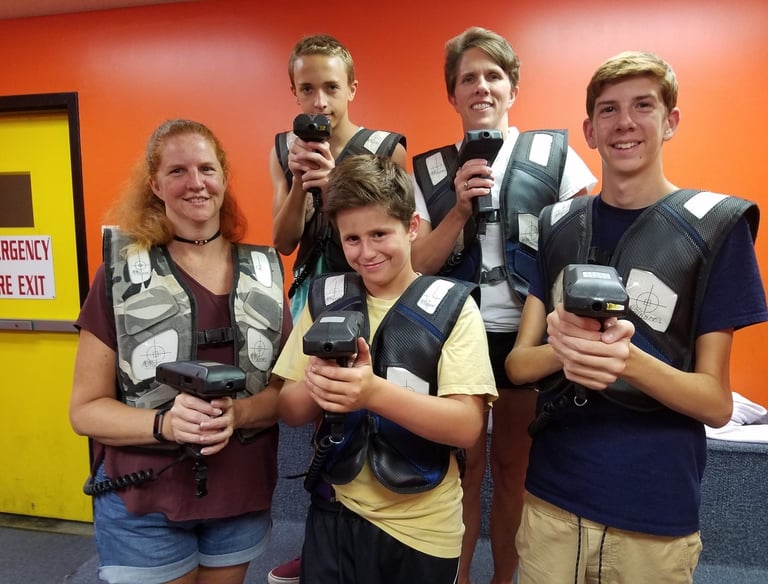 family posing for laser tag
