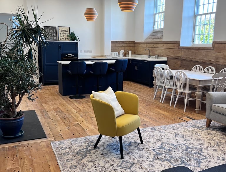 Finished living and dining area with modern furniture and restored architectural details.