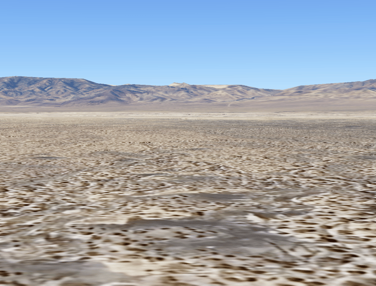 a desert scene with a lone horse in the foreground