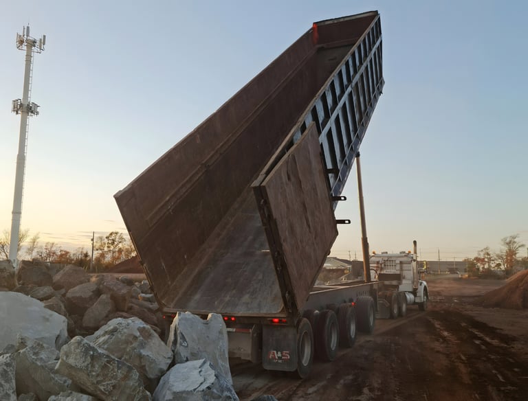 aggregate delivery truck supplying materials to active construction site