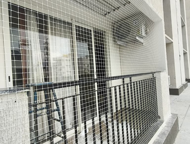 A close-up of a sturdy balcony safety net tightly secured around a residential balcony in Kolathur.