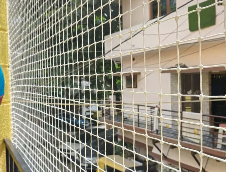 Close-up of a sturdy balcony safety net securely installed on a residential balcony in Whitefield.