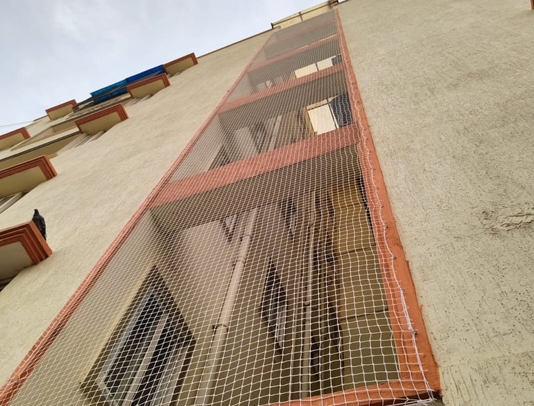Apartment duct area covered with a custom-fitted pigeon net, ensuring safety and cleanliness.