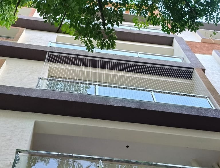 Close-up of a sleek invisible grill perfectly fitted on a Besant Nagar balcony.