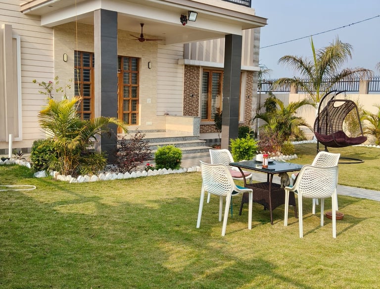 Modern PG with a green lawn, outdoor patio furniture, and a hanging swing chair.