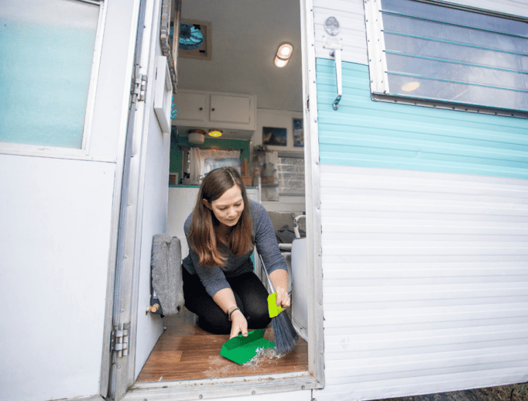 a woman cleaning a camper