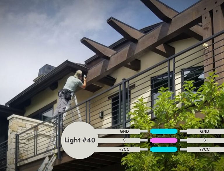 Professional installing outdoor soffit lighting on a modern balcony with wiring diagram.