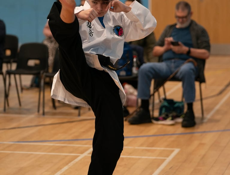 Black belt Junior practising kicks in our Tunbridge Wells classes.