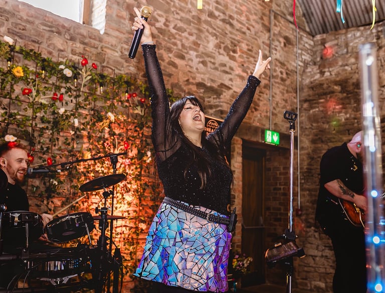 a woman in a skirt and a man in a black shirt and a microphone