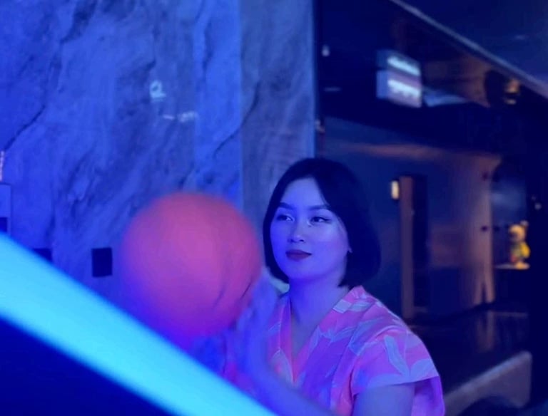 a woman in a pink dress playing with a ball