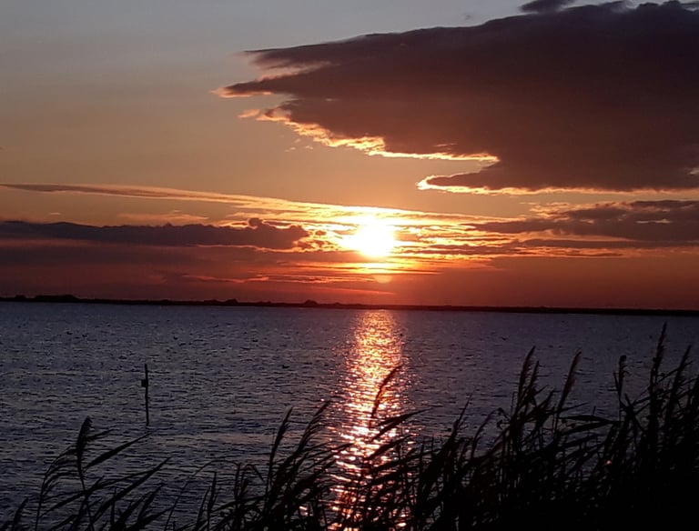 a sunset over a body of water