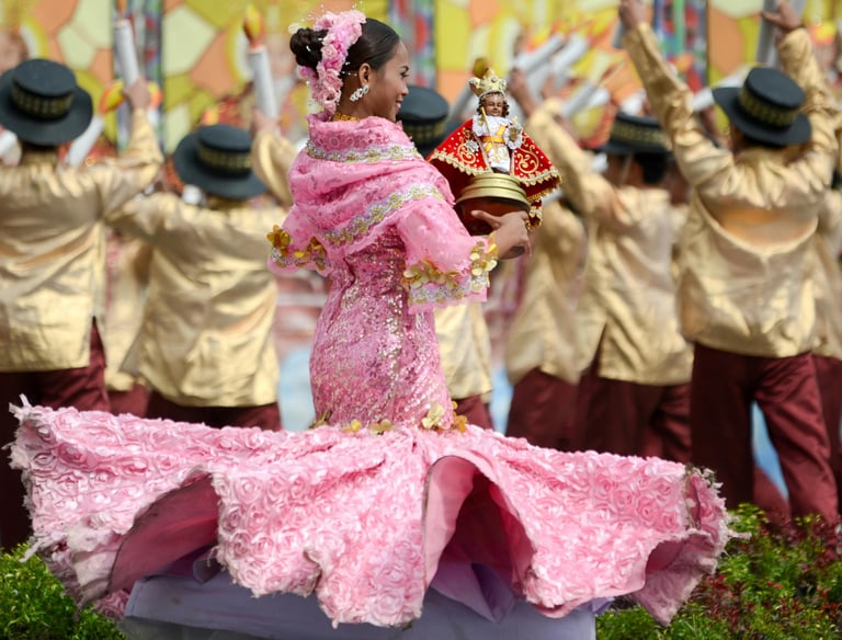 a woman dancing the Sinulog