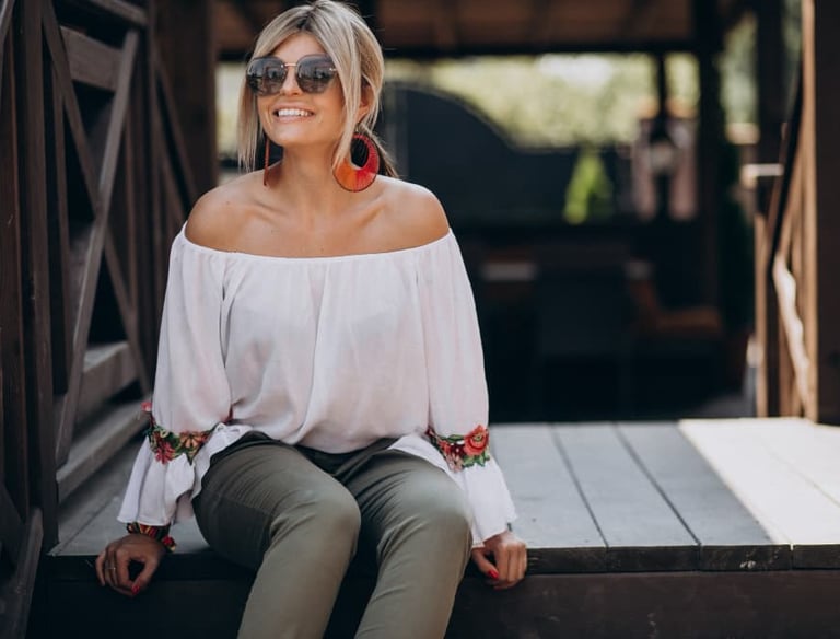 a sugar mommy in a white blouse and sunglasses