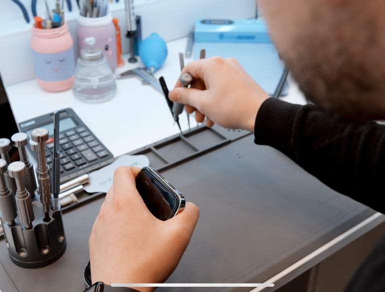 a man is holding a cell phone in his hand